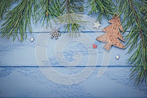 Christmas or New Year mock up with empty space: pine branches  wooden Christmas tree and some decorations on the blue boards