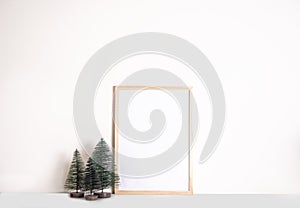 Christmas New Year mock up frame with small toy fir trees for decoration. Space for text. Seasons greetings template