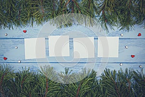 Christmas or New Year mock up: pine branches and four white stickers on the blue boards