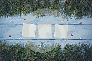 Christmas or New Year mock up: pine branches and white stickers on the blue boards