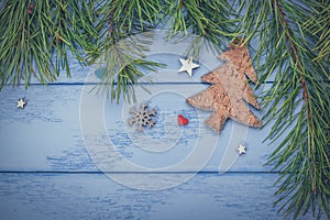 Christmas or New Year mock up: pine branches  wooden Christmas tree and some decorations on the blue boards