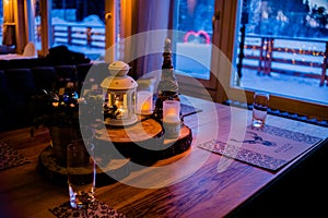 Christmas or New Year party table. Toned image.The concept of a festive dinner.festive branch decoration, candles and gliterring