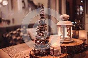 Christmas or New Year party table. Toned image.The concept of a festive dinner.festive branch decoration, candles and gliterring