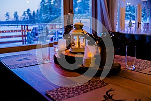 Christmas or New Year party table. Toned image.The concept of a festive dinner.festive branch decoration, candles and gliterring