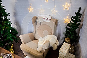 Christmas and New Year photo studio, green tree, soft chair, garlands stars, plush toy, white wall (2).