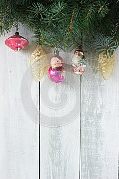 Christmas or New Year`s background with fir branches and old Christmas-tree toys on a white background.