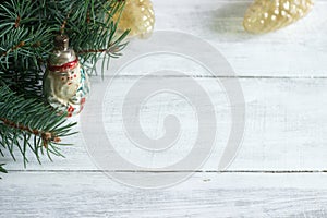 Christmas or New Year`s background with fir branches and old Christmas-tree toys on a white background.