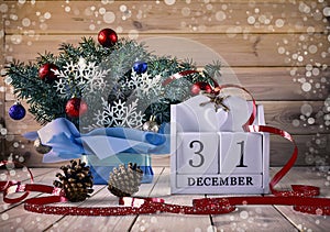 Christmas and New Year\'s bouquet of Christmas tree branches and a calendar with the date December 31.