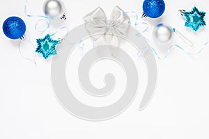 Christmas or New Year`s composition 2021. Beautiful xmas blue and silver decorations on a white background and copy space.
