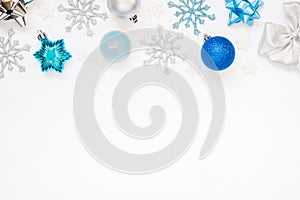 Christmas or New Year`s composition 2021. Beautiful xmas blue and silver decorations on a white background and copy space.