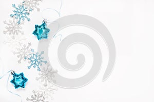 Christmas or New Year`s composition 2021. Beautiful xmas blue and silver decorations on a white background and copy space.