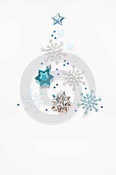 Christmas or New Year`s composition 2021. Beautiful xmas tree made of blue and silver decorations on a white background and copy