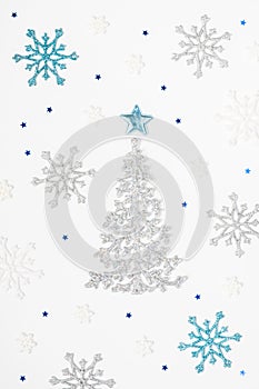 Christmas or New Year`s composition 2021. Beautiful xmas tree made of blue and silver decorations on a white background. Greeting