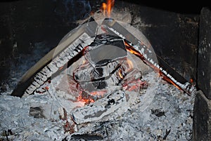 Christmas and New Year's fireplace, coals, firebrands and ash from burnt firewood.