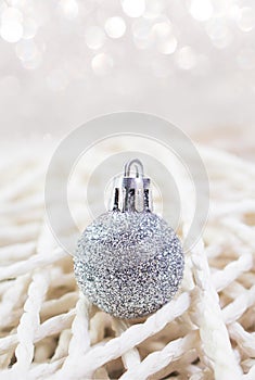 Christmas New Year\'s silver toy on background handmade from threads. Defocus bokeh, soft focus. Vertical