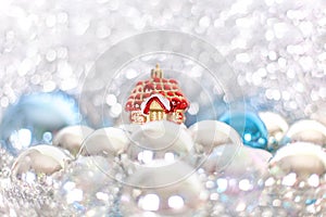 Christmas and New Year`s toy fairy tale red house in snowdrifts and snow of Christmas balls and tinsel in blue and white colors