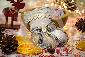 Christmas and New Year`s winter holiday Christmas stocking on the table. Composition. Garland, deer figurine, fir cones