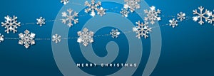 Christmas or New Year silver snowflake decoration garland on blue background. Hanging glitter snowflake. Vector illustration