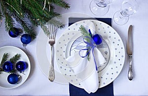 Christmas or New Year table decoration in white and blue colors.