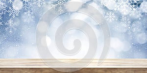 Christmas and New year theme background. Wooden table with winter snowfall background. Panoramic banner.