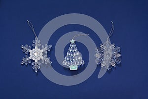 Christmas New year toys on a dark blue background. Decoration in the form of snowflake and herringbone. Top view, flat lay