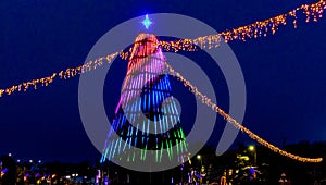 Christmas and New Year tree decorated with colorful  lights at night_