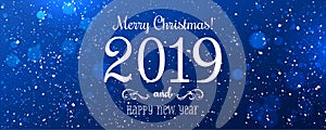 Christmas and New Year Typographical on snowy blue Xmas background with snowflakes, light, stars.