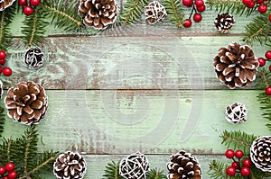 Christmas, new year,winter,Xmas frame green wooden background with fir tree and pine cones. Flat lay mock up. Top view