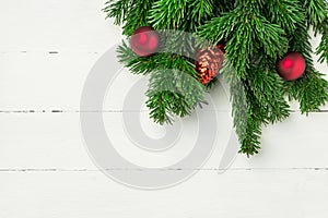 Christmas new Years background in retro vintage style with fresh fluffy fir tree branches red ornament balls on white plank wood