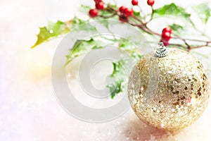 Christmas New Years greeting card winter forest golden glittering ornament ball holly berry branch in snow