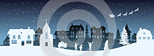 Christmas nigh panorama. Silhouettes of kids looking at Santas sleigh. Celebration scene. Paper village landscape