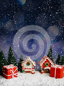 Christmas night scene with ginger houses, candy canes, pine trees and Santa on vivid blue background. Creative Xmas or New Year