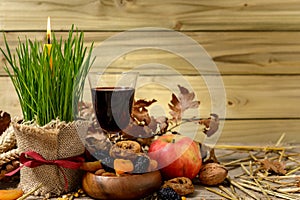 Christmas oak tree, wine, candle, bread and dried fruits