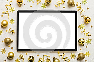 Christmas online shopping from home tablet pc with blank white display top view. Tablet with copy space on colored