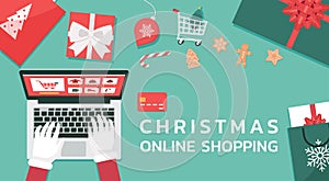 Christmas online shopping top view concept, santa Claus hand makes order on laptop and text