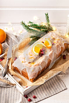 Christmas orange cake with cranberries and sugar icing