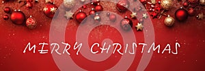 Christmas ornament banner with Red and gold baubles and stars on a festive red background