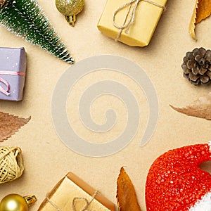 Christmas ornament and gift boxes, dry plant on brown background
