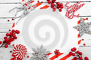 Christmas ornament made of red adornment on wooden background