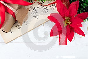 Christmas ornament and music sheet on white natural wooden table