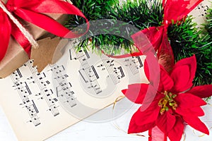 Christmas ornament and music sheet on white natural wooden table