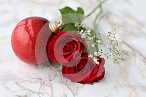 Christmas Ornament with Red and White Flowers on a Marble Surface