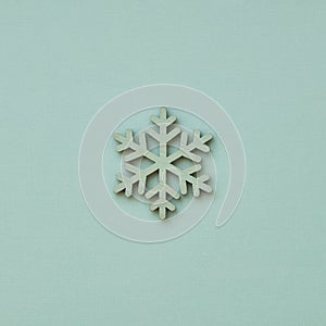 Christmas ornament in the shape of a snowflake on a blue background