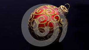 Christmas ornament single red ball on black background. Christmas ornament concept. Elegant and luxury christmas decor