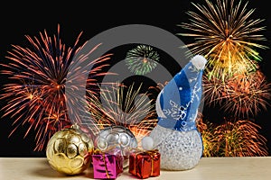 Christmas ornament and toy doll on fireworks backgrounds