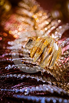 Christmas ornaments and balls with glitter background in violet and golden tones