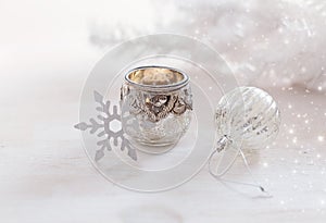 Christmas ornaments and candle over white background