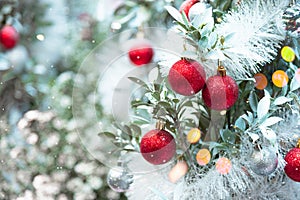 Christmas ornaments decorating on Christmas snowy tree. Merry Xmas and happy new year concept background