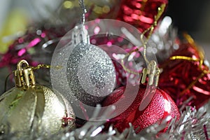 Christmas ornaments decoration with white, golden and red Christmas balls closeup.