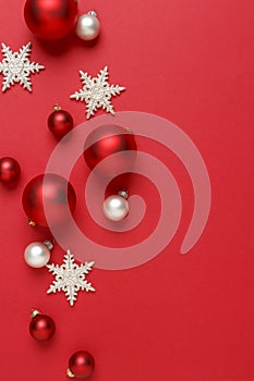 Christmas ornaments decorations background. Red, silver and white glass baubles balls with glitter snowflakes vertical